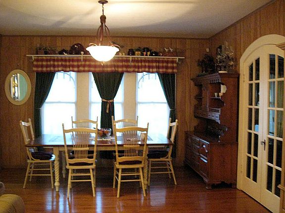 Dining room with hardwood floors and French doors opening to formal living room.