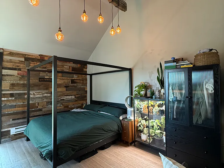 Studio set up with bed near kitchen