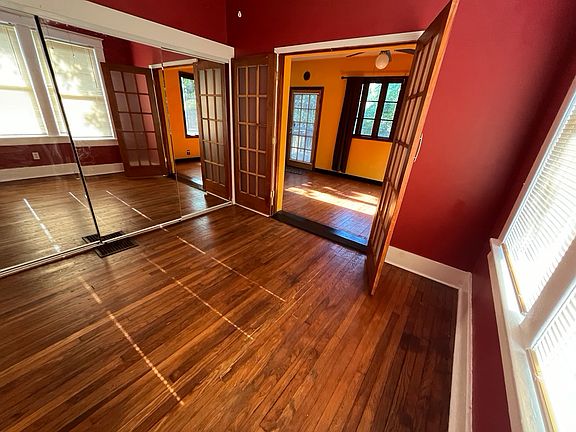 Second bedroom is off of large sitting room and has closet inside three mirrored sliding doors.