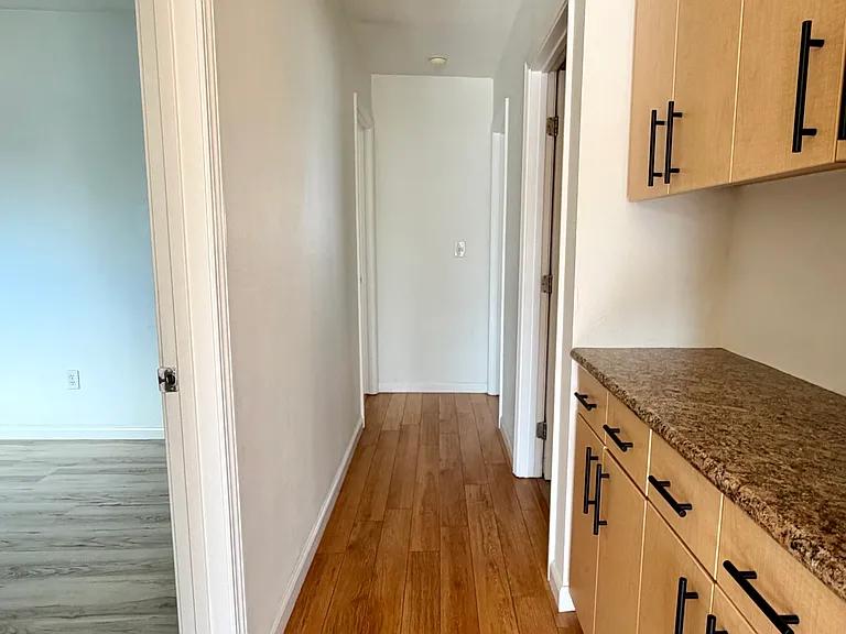 Hallway to bedrooms, with storage