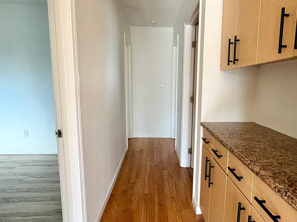 Hallway to bedrooms, with storage