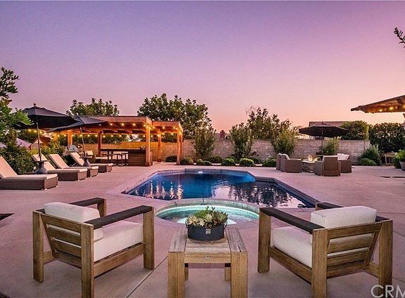 Resort-style backyard with a pebble-finished salt water pool & spa