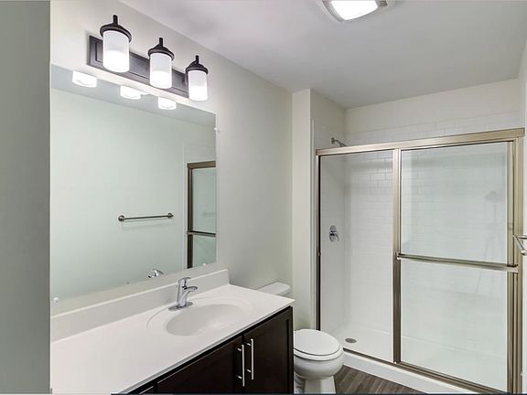 Second bathroom features a linen closet, spacious vanity, and stand-up shower