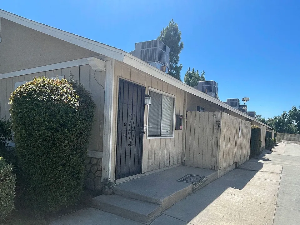 Parking lot driveway and private porches at Eucalyptus Apartments in Morneo Valley, California.