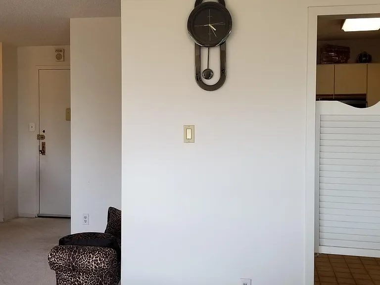 View from dining room to the kitchen with french doors (right) and foyer (left).