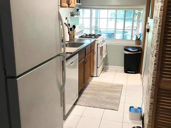 Fully equipped kitchen with gas stove, refrigerator, and dishwasher