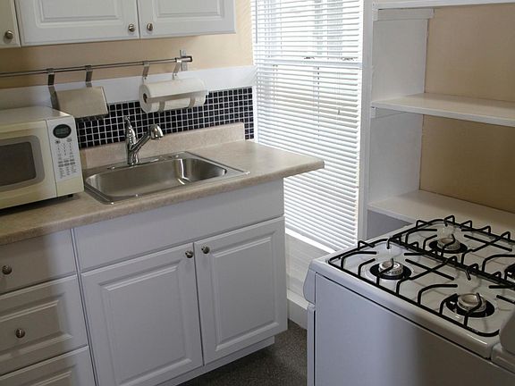 Kitchen with gas range, pantry, built ins, newer cabinets.