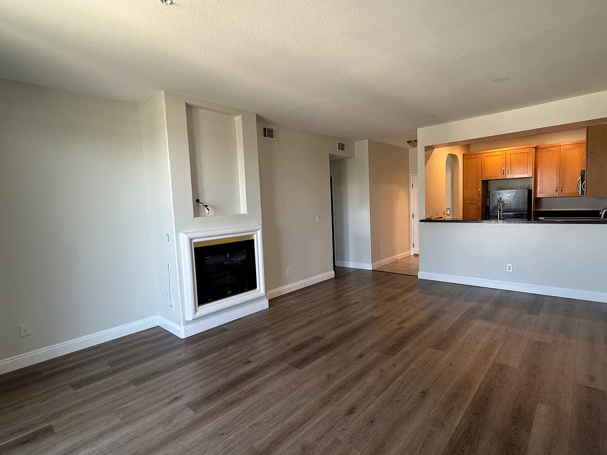 living room from corner - featuring gas fireplace and recessed tv mounting area. - 555 Maine Ave #316