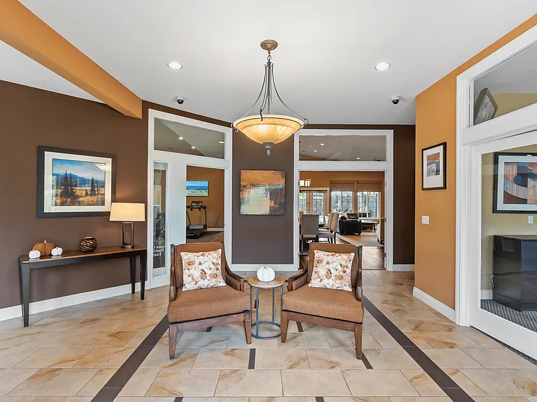 Inviting community lounge with comfortable seating, warm finishes, and elegant lighting.
