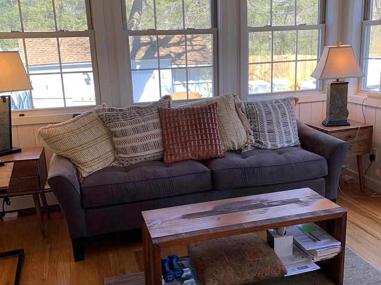 sunroom living area. Windows on three sides. Just gorgeous