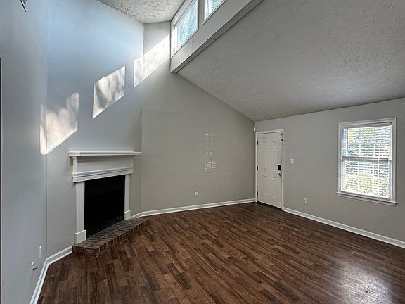 Living room with cozy fire place and sun windows