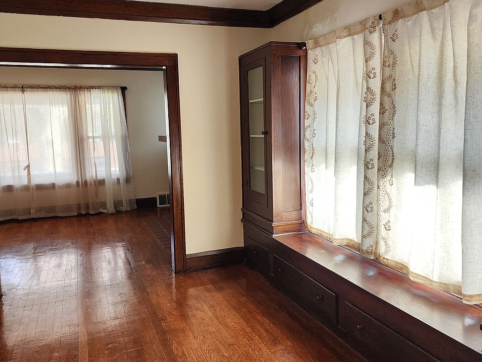 Spacious Dining Room with Hardwood floor and built-in cabinets. Curtains included