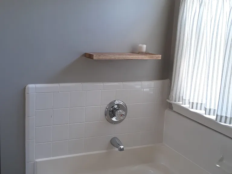 Cafe curtain for sunlit room with privacy. Garden tub for soaking. Shelf for whatever!