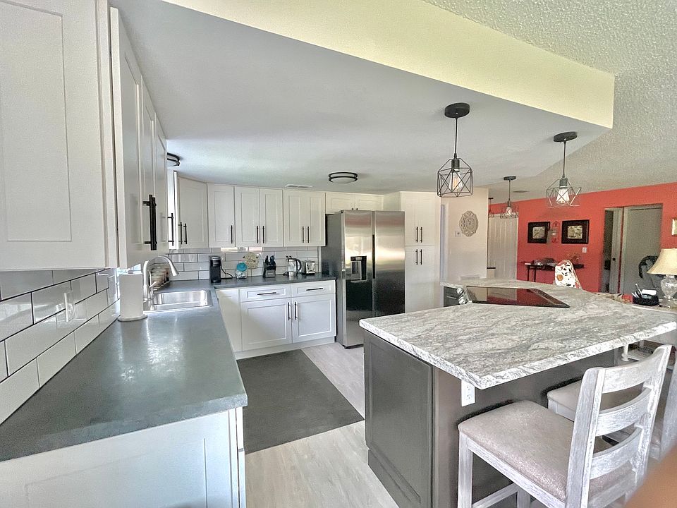 Brand new remodeled modern kitchen boasting an abundance of cabinets, including a pantry as well as plenty of counter space for cooking. The stove/oven is positioned to view t.v. while food prepping and cooking.