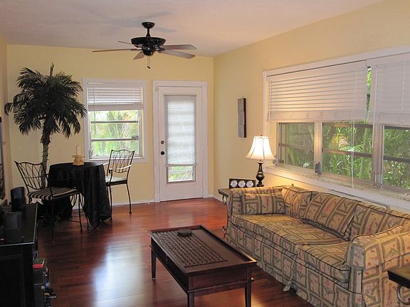 Cozy living area surrounded by windows and trees