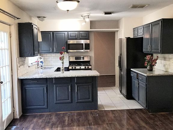 Updated cabinet paint with stainless steel door handles