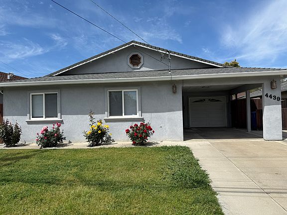 Front with car garage and carport