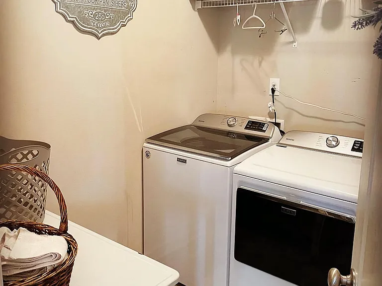 Laundry room - new washer n dryer, folding table, two vacuums, storage