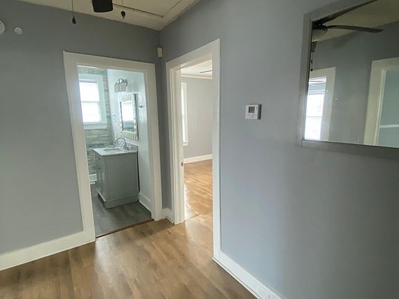 Large study area with ceiling fan and hardwood flooring.