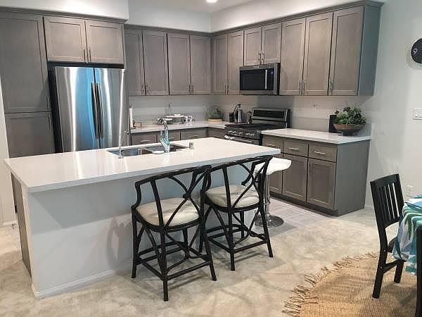 Kitchen with stainless steel appliances: gas 5 burner cooktop, electric convection oven, microwave, double door fridge/bottom freezer w/ice maker
Dishwasher is in the center island near sink