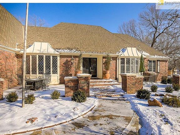 Marvelous brick patios flank the splendid exterior of the front entrance!