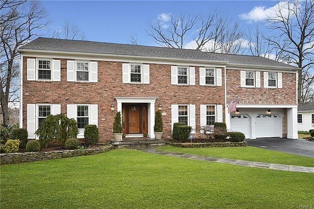 Welcome to this beautiful brick-front 6 bedroom, 4.1 bath Quaker Ridge Colonial!