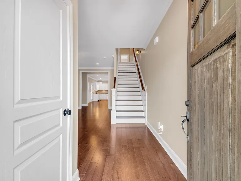 Front door opens to small foyer leading to stairs and open floor plan living room
