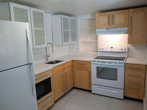 Completely remodeled kitchen with new cabinetry, countertops & tile backsplash. Appliances are like-new. Microwave is included.