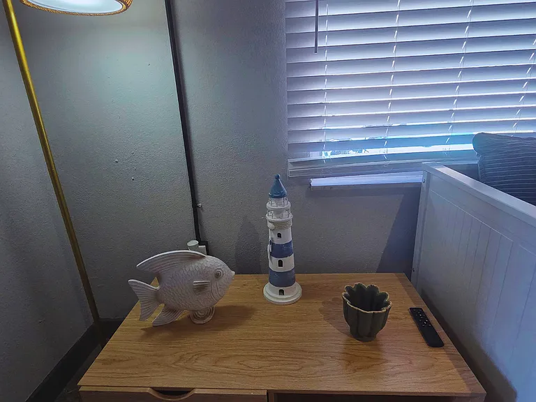 Beach-inspired coffee table with anchors, fish decor, and elegant lighting.