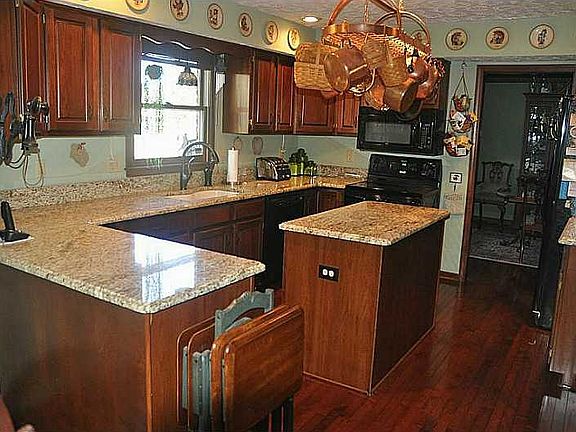 Kitchen. SPACIOUS GOURMET KITCHEN W/GRANITE COUNTER TOPS, PLENTY OF CHERRY CABINETS, 9" CAST IRON SINK, PANTRY,  & CENTER ISLAND.