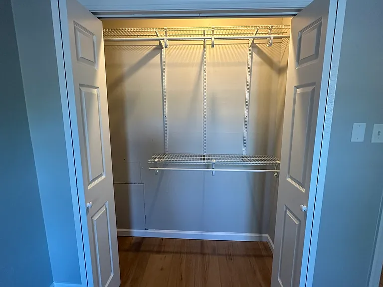 Bedroom closet with build-in shelving and hanging space