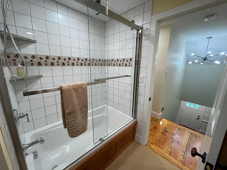 Upstairs bath is shared by the twin and queen bedrooms and has a large soaking tub