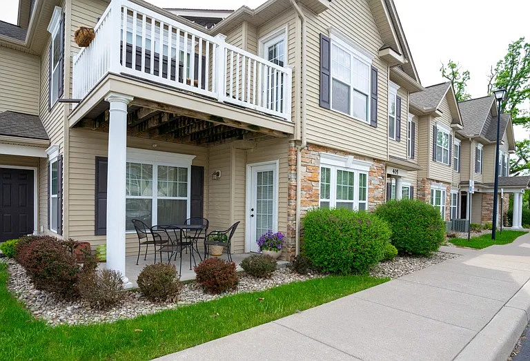 View of private patio and private balcony and sidewalk