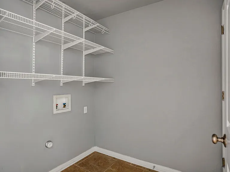 Laundry room with pre-built shelves. Brand new washer and dryer.