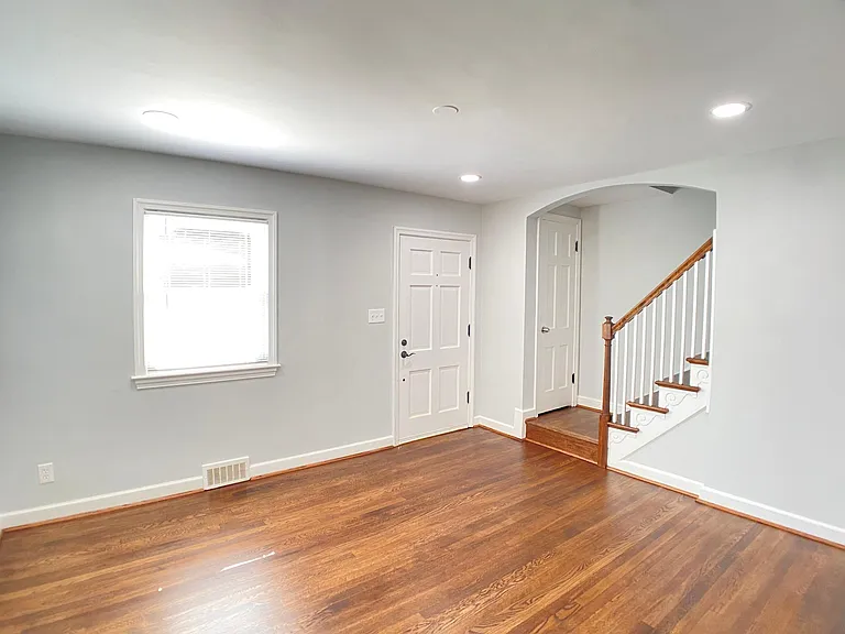 Large living room area with recessed, dimmable lighting.