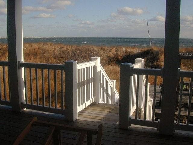 Rental private porch leading down to middle deck to path to beach.