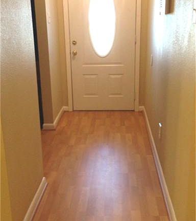 Entry with recent laminate flooring and leaded glass front door