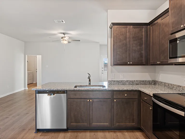 The kitchen looks out into the living room.