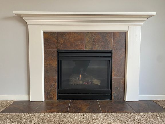Natural gas fireplace ignited with the flip of a light switch.