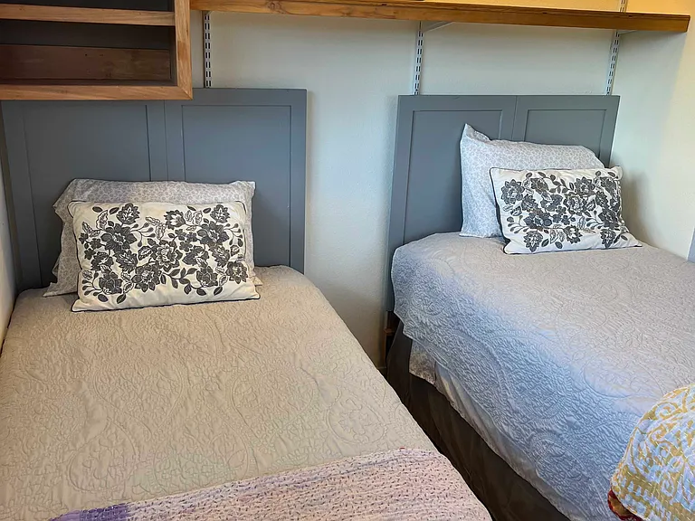 2nd bedroom with 2-beds and shelving