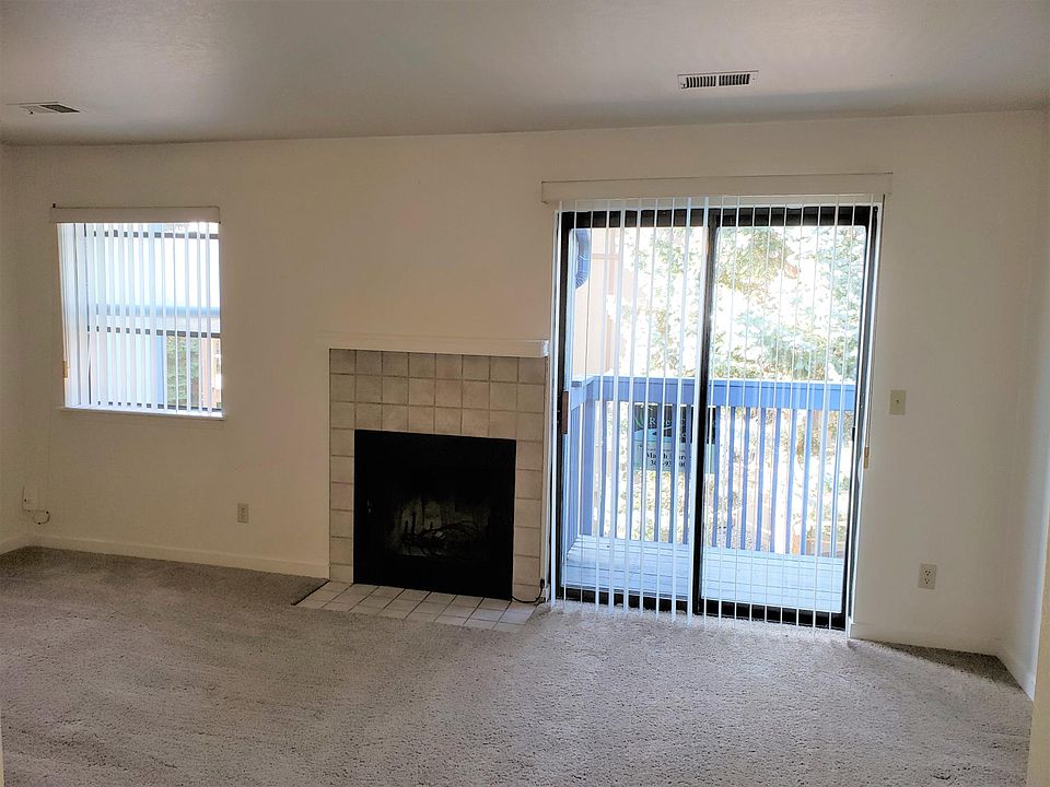Living room with fireplace and balcony
