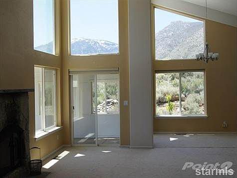 Great room and dining area with mountain views.