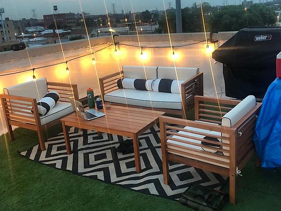 Rooftop furniture and grill on private rooftop.