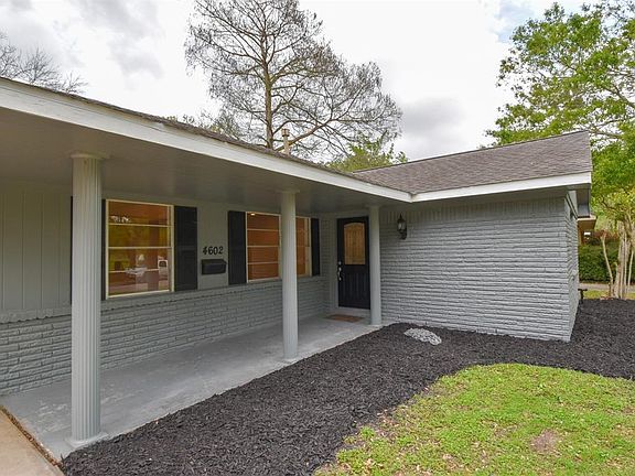 Welcoming entrance with covered walkway, and beveled glass front door.