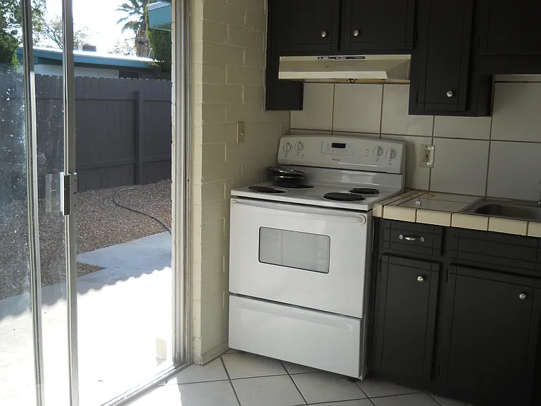Kithen with Sliding door to large fenced backyard.