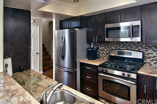 Remodeled kitchen includes side by side stainless steel Frigidaire refrigerator!