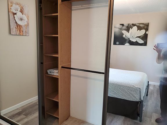 Inside the wall to wall mirrored closet. There are lots of shelves for storage on both side of the closet.