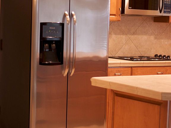 Stainless refrigerator w/water and ice in door.