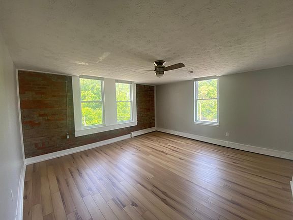 Large living room with exposed brick