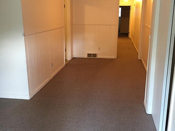 Dining room. The kitchen is on the left; shows hallway to bathroom and bedrooms.